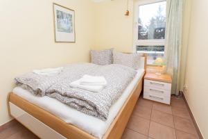 a bedroom with a bed with two towels on it at Ostseeresidenz - Whg 29 in Zingst