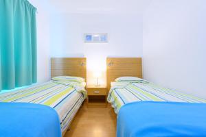Katil atau katil-katil dalam bilik di Apartamentos Loma Estrella