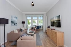 a living room with a couch and a table at Villa Seeblick "Wolgastsee" in Ahlbeck