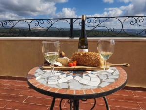 a table with a bottle of wine and two glasses at Castello Panorama in Abirim +5 photos