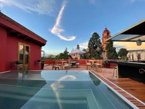 a swimming pool in front of a house at Hotel Casa Oratorio "Adults Only" in San Miguel de Allende