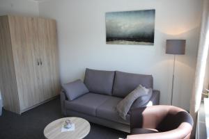 a living room with a couch and a table at Hotel Villa Undine in Grömitz