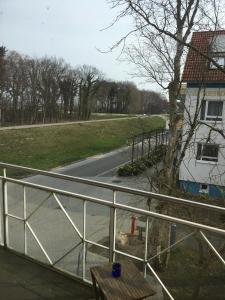 a view of a road from a balcony with a fence at Meerlust App 6 in Zingst