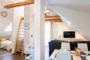 a living room with a staircase and a living room with a couch at Apartmani Vesna Tuheljske toplice in Tuheljske Toplice