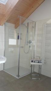 a bathroom with a shower with a sink and a table at Ferienhaus Casa Rosa - LienzOsttirol in Leisach