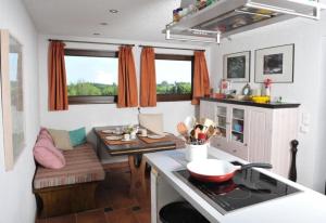 a kitchen with a table and a counter top at Chalet Charbonnier in Wolpadingen