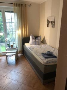 a small bedroom with a bed and a window at Nele 02 in Zingst