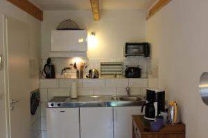a small kitchen with a sink and a microwave at "Rosenkate 1" in Riepsdorf