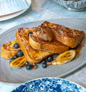 a plate of french toast with blueberries and bananas at Kimpton Banneker Hotel, an IHG Hotel in Washington