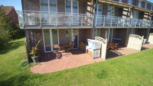 a house with a deck and a balcony at FEWO Kornblume in Hohen Wieschendorf