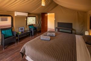 a bedroom with a bed in a tent at Kings Creek Station in Kings Canyon