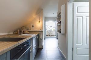 a kitchen with a sink and a counter top at Whg 16 - Sol in Zingst