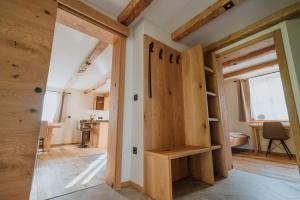 a room with a wooden closet with a door at Cottage Planska koča in Vitanje