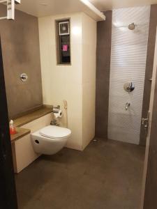 a small bathroom with a toilet and a shower at Hotel Udayanraje Palace in Ahmadnagar