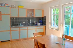 a kitchen with a wooden table and a wooden dining room at Illing, Wolfgang FW 8 in Zingst