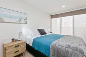 a bedroom with a bed and a dresser and a window at Apollo Blue Pearl ~ Oceanfront ~ Free Wifi in Apollo Bay