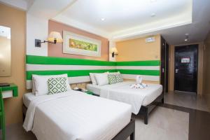 Postel nebo postele na pokoji v ubytování Red Coco Inn de Boracay