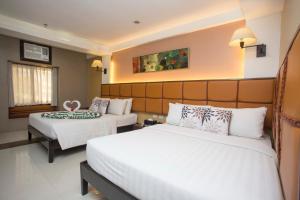 Postel nebo postele na pokoji v ubytování Red Coco Inn de Boracay