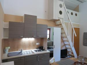 a kitchen with a sink and a staircase at Ferienwohnung Vöst in Peiting