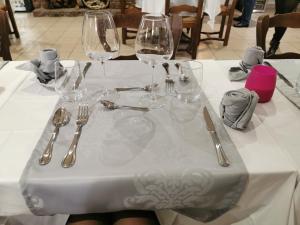 a table with wine glasses and utensils on it at Auberge Du Riou in Puget-Rostang +31 photos