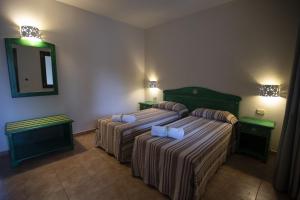 A bed or beds in a room at Le Vanille