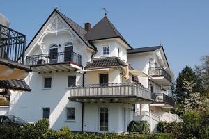 uma casa branca com varandas ao lado dela em Villa Carpe Diem, FW 9 em Zingst