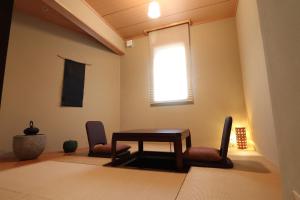 a dining room with a table and two chairs at 軽井沢 - Karuizawa Villa H24 - ペット可 - 条件付き小型犬OK in Oiwake