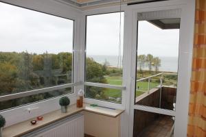 a room with a window with a view of the ocean at Hanseat II App 184 "Meerblick Grömitz" in Grömitz