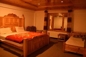 A bed or beds in a room at Abbott Hotel Kaghan