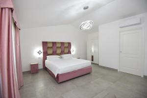 Säng eller sängar i ett rum på Agriturismo Borgo Imperiale