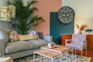 a living room with a couch and a table at StayVista at Boho Banyan with Pvt Pool & Garden in Alibaug