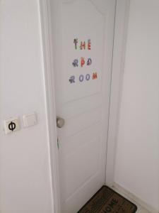 uma sala com uma porta branca com letras em City Apartment em Lerápetra