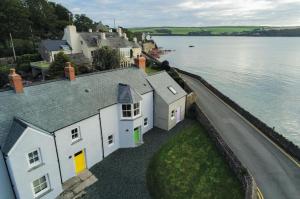 an aerial view of a house next to a body of water at Brook Cottage - 1 Bedroom Cottage - Dale in Dale
