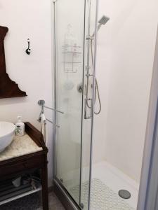 um chuveiro com uma porta de vidro na casa de banho em B&B L ORTENSIA em Bolsena