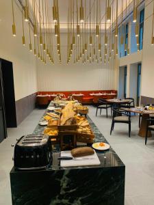 a long table with food on it in a restaurant at Kozmo Hotel Suites & Spa - The Leading Hotels of the World in Budapest