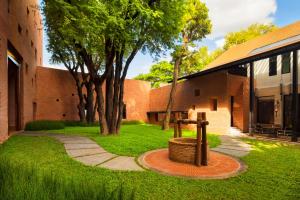 a brick building with a basket in the grass at Cross Chiang Mai Riverside - formerly X2 Chiang Mai Riverside in Chiang Mai