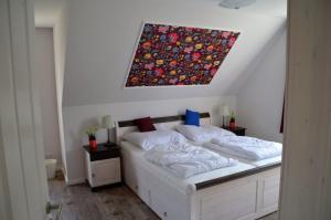 a bedroom with a bed with a painting on the wall at Dreamhus Borgsum in Borgsum