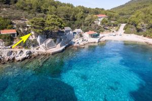 an aerial view of a beach with a yellow triangle in the water at Guesthouse Karbuni (217) in Blato