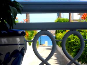 a view of a balcony with a vase on a fence at Apartments Papafotis in Alinda