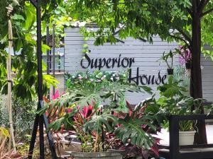 a garden with plants and a sign that reads victory hospice at Superior House Khaoyai in Ban Khanong Phra Klang (1)