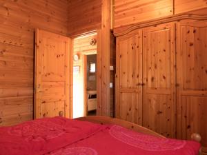 a bedroom with a bed in a wooden room at Ferienhaus Nr 24, Typ A, Feriendorf Jägerpark, Bayerischer Wald in Viechtach