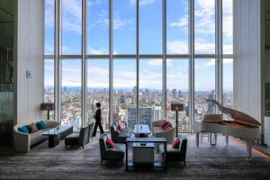 a person standing in a room with a large window at Osaka Marriott Miyako Hotel in Osaka