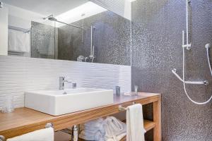 a bathroom with a sink and a shower at Hotel Monte Rosa in Chiavari