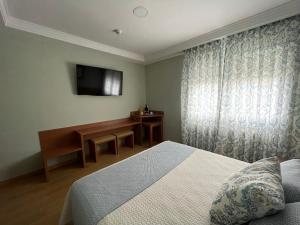 A bed or beds in a room at Hotel Cies