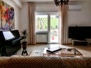 a living room with a large window and a coffee table at Feudo di Castelmozzo in Santa Paolina