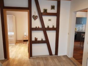 a living room with a wooden shelf in a wall at Waldblick - a48825 in Lauscha