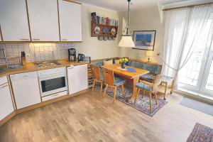 a kitchen with a table and a dining room at Kranich VIII, FW 39 in Zingst