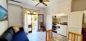 a living room with a couch and a table and a kitchen at Granada Apartments Familiar Deluxe in Portinatx
