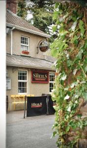 a building with a sign that says shilds sandwiches at Basil Sheils B&B Accommodation Armagh in Armagh