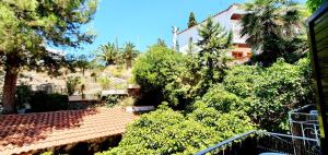 an overhead view of a house with trees and bushes at Granada Apartments Familiar Deluxe in Portinatx